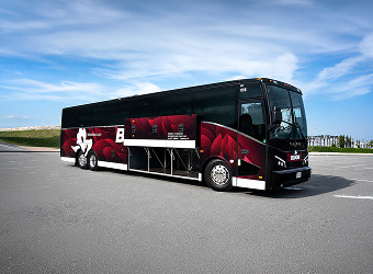 Black and red bus on road